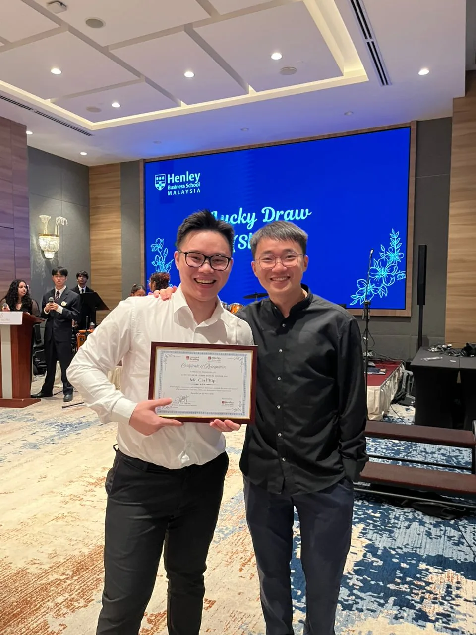 Carl Yip receiving Certificate of Recognition from Henley Business School