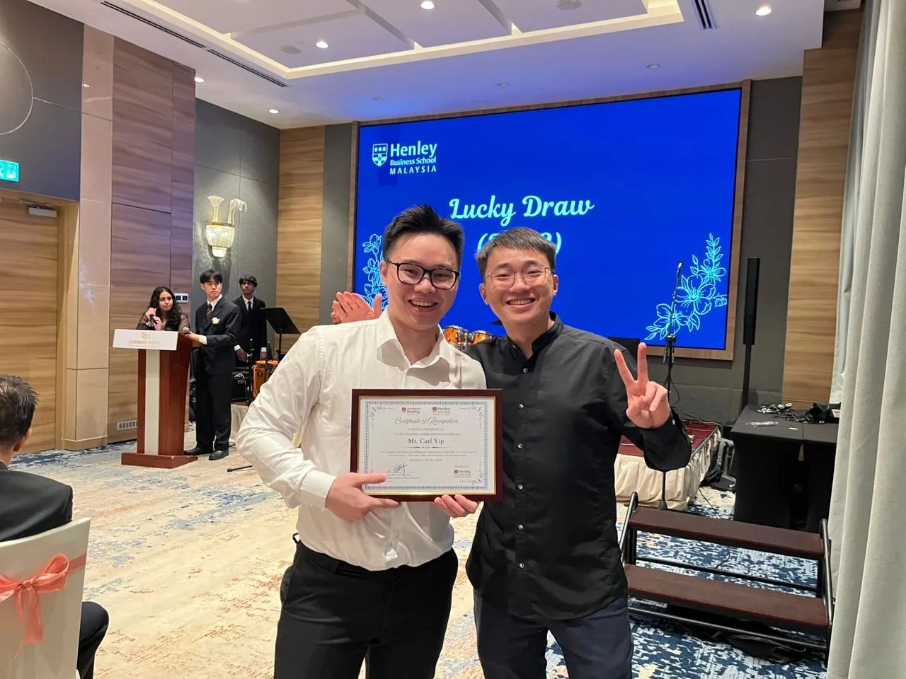 Carl Yip celebrating with Certificate of Recognition at the gala dinner
