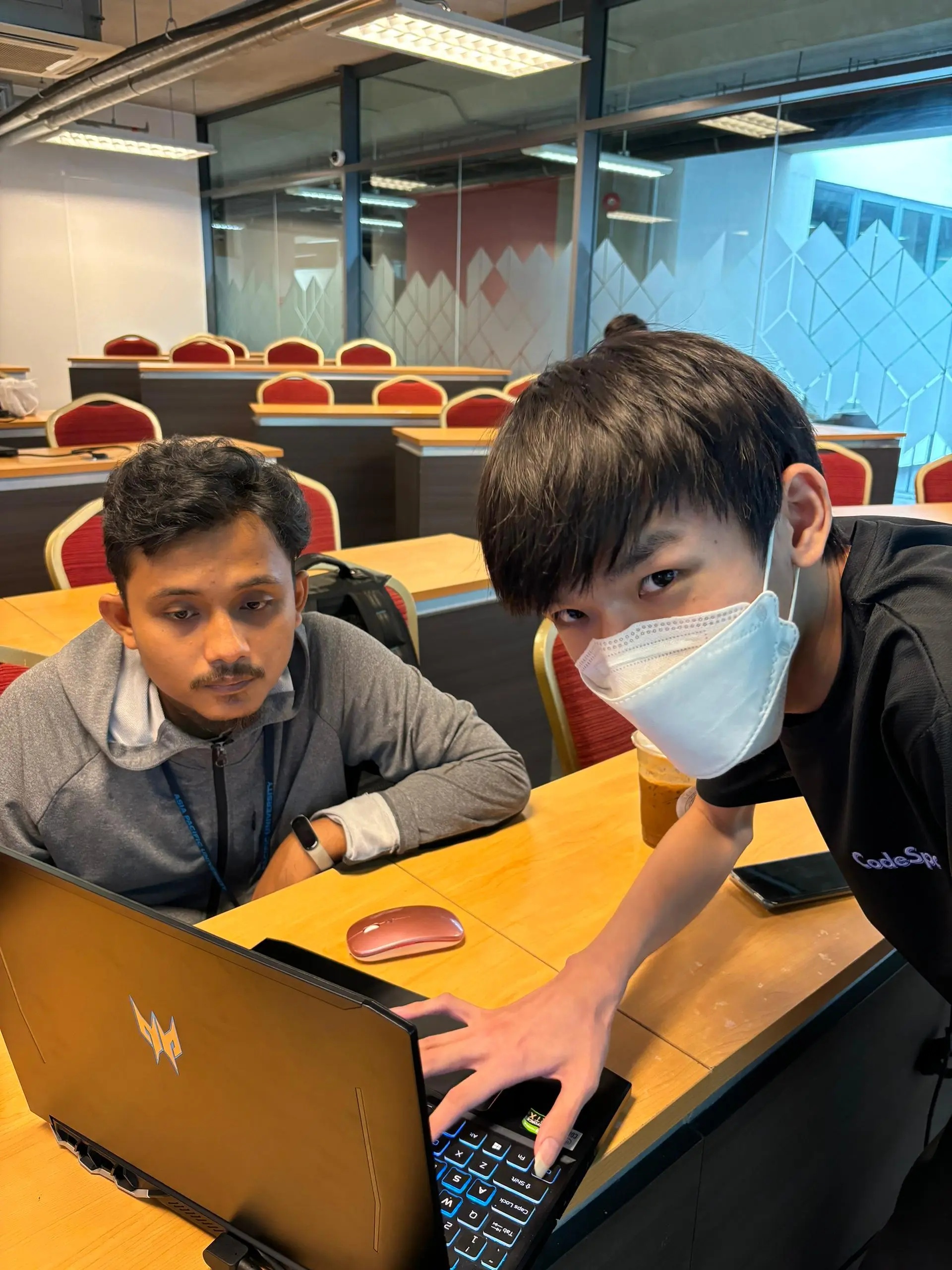 Mentor assisting student with code