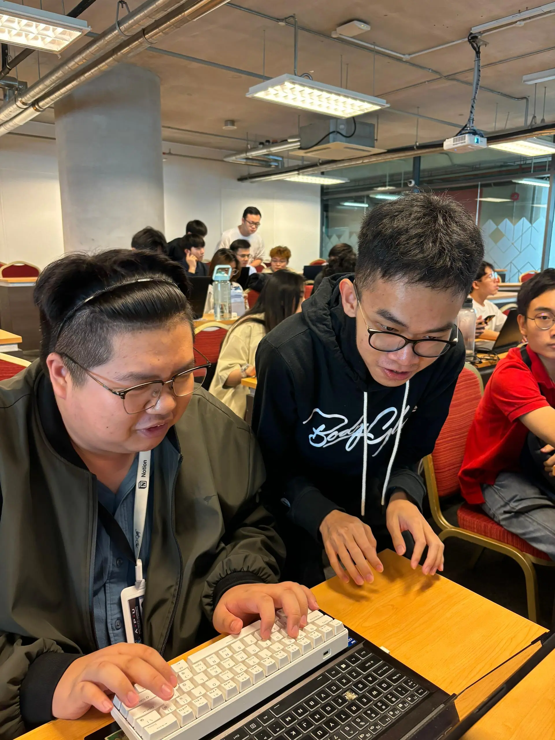 Mentor assisting directly on keyboard
