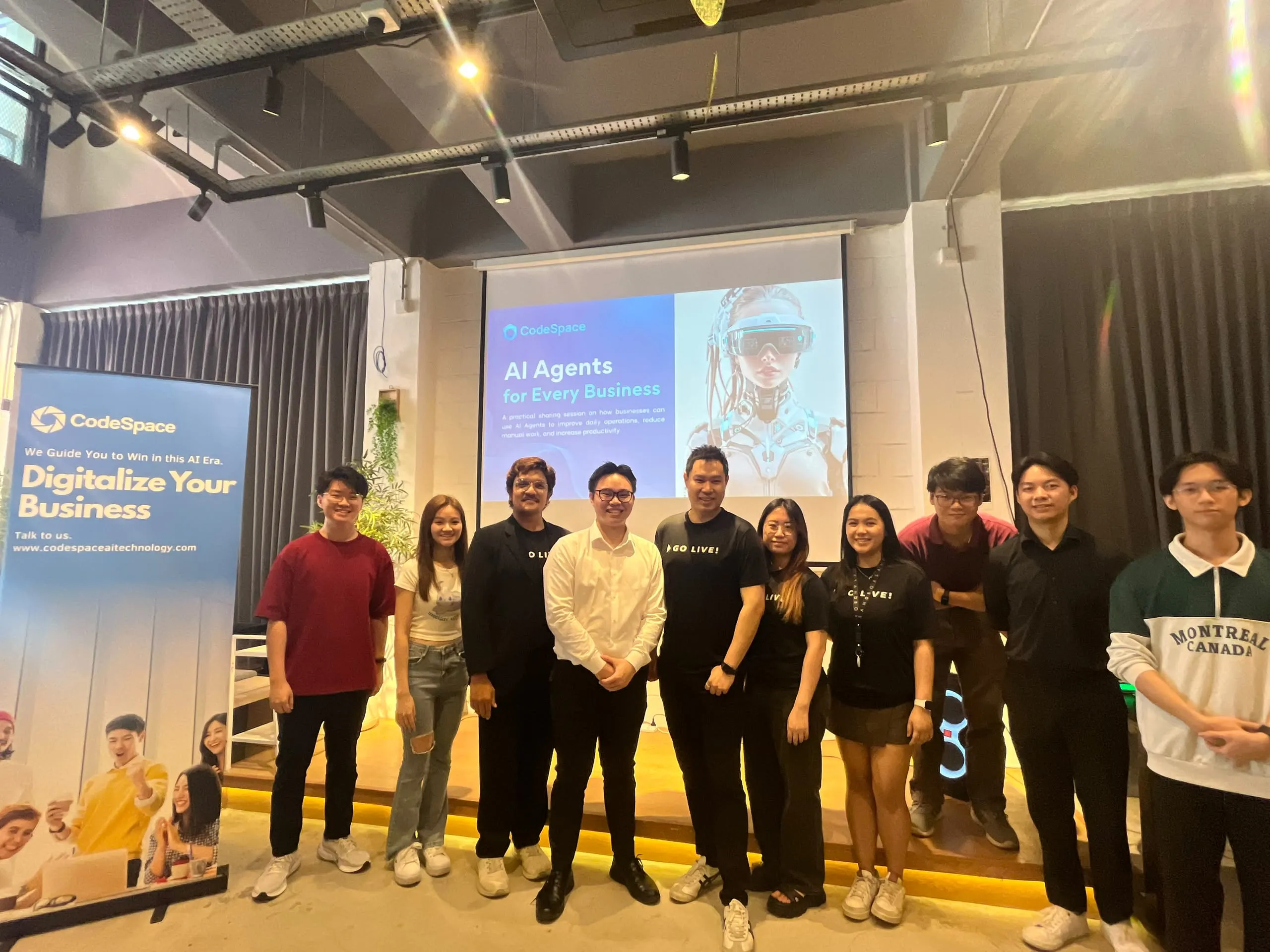 CodeSpace team photo in front of banner