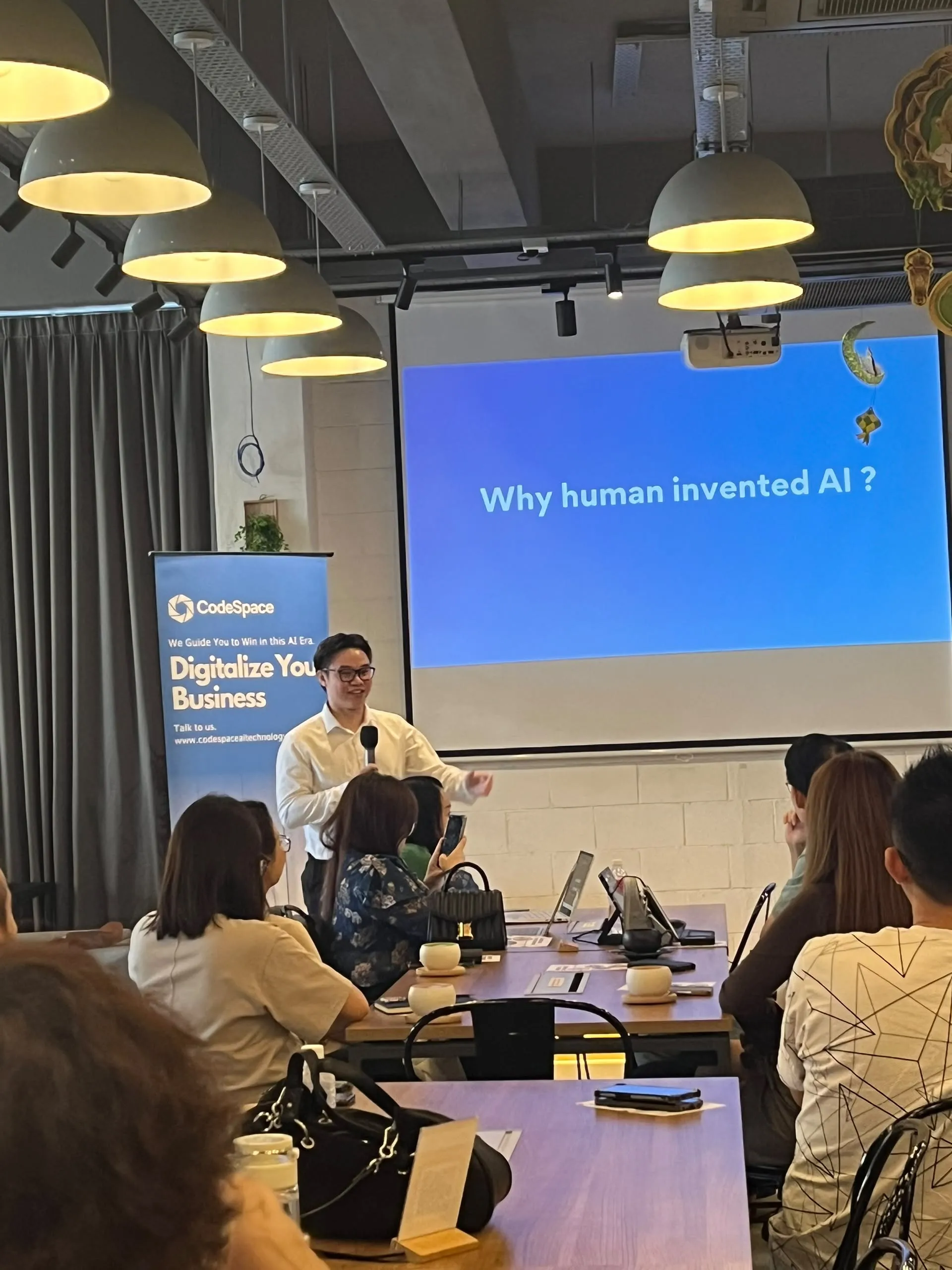 Presenter engaging audience on AI origins