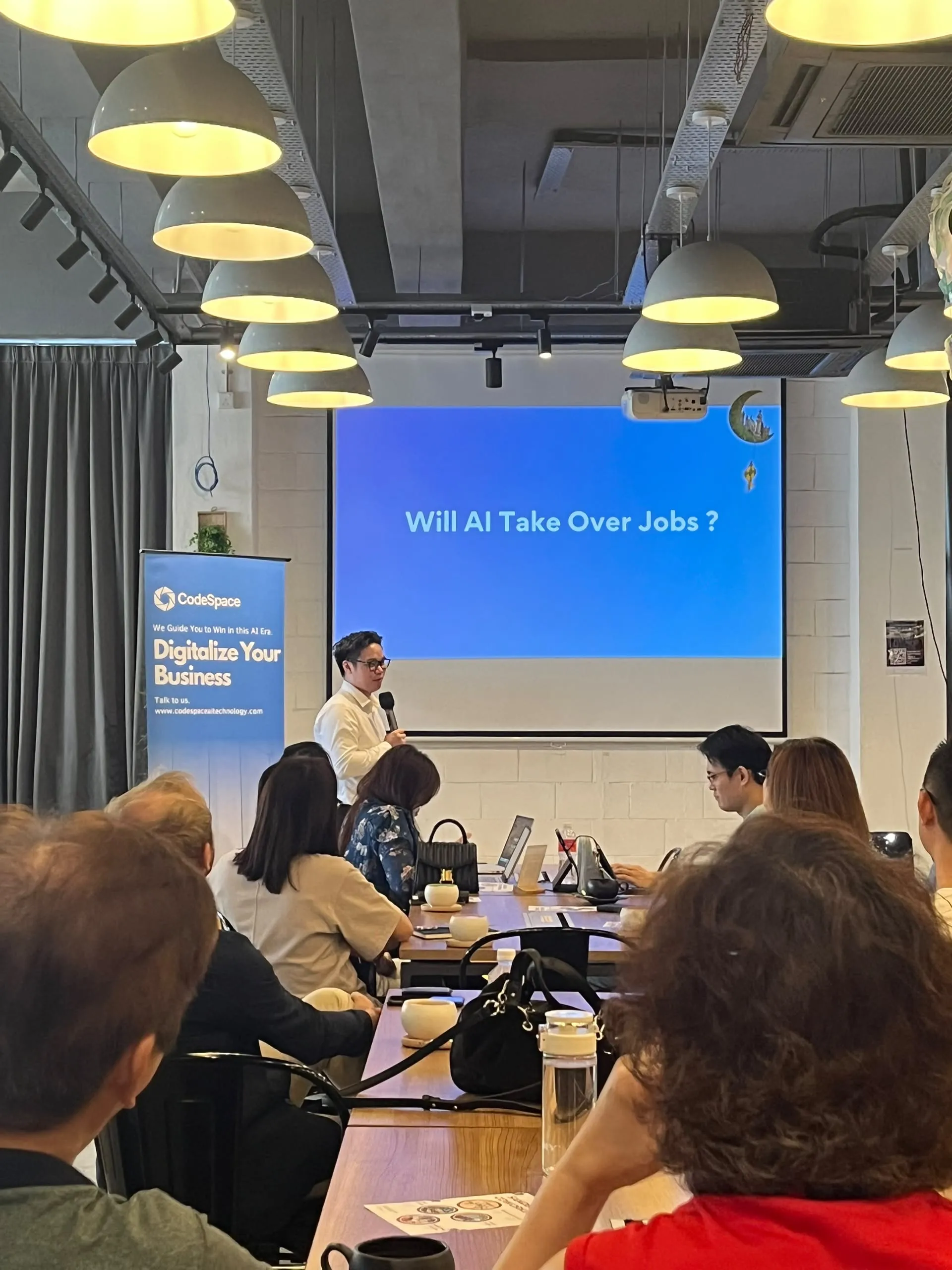 Presenter discussing Will AI Take Over Jobs?